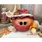 This is a fall apple decoration. It is a real gourd with a happy face  carved into it. This gourd is named Apple and has a lacy handmade hat